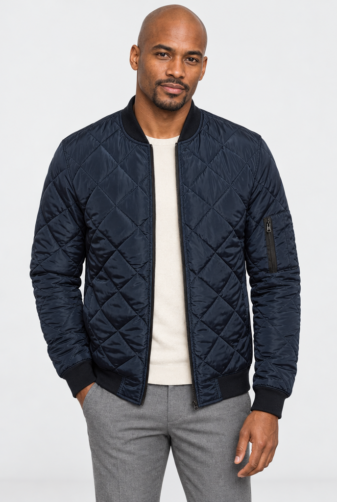 Navy diamond-quilted bomber jacket, studio hero