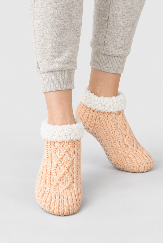 Peach cable-knit sherpa-lined slipper socks, on-feet hero