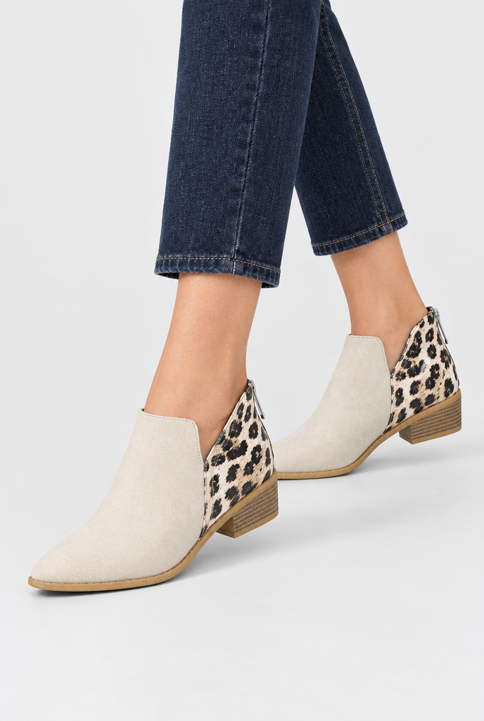 Cream leopard-panel pointed toe ankle booties, on feet