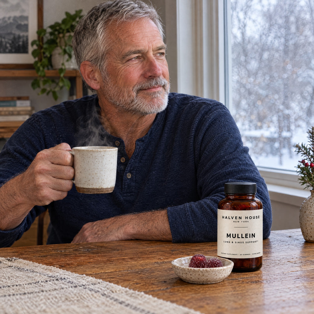 Man with a cup of tea and Halven House Mullein Gummies at breakfast