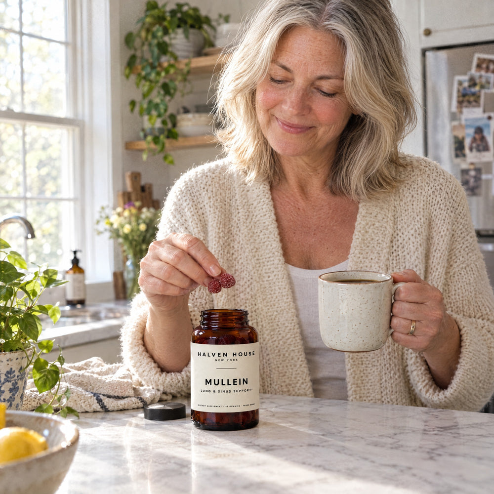 Woman taking Halven House Mullein Gummies with her morning coffee